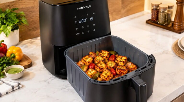 A sleek dark grey ceramic air fryer basket sitting on a modern kitchen counter for best ceramic air fryers in india